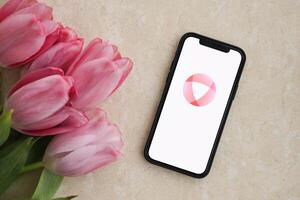 KYIV, UKRAINE - FEBRUARY 23, 2024 Open logo of famous dating website or app on iPhone display photo