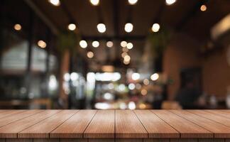 Empty wooden table top with lights bokeh on blur restaurant background. photo