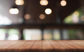 Empty wooden table top with lights bokeh on blur restaurant background. photo