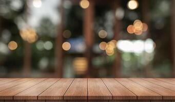Empty wooden table top with lights bokeh on blur restaurant background. photo