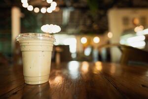 Generated imageIced coffee with take away plastic glass on wooden table. photo
