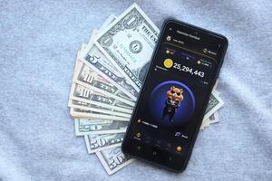 KYIV, UKRAINE - JUNE 20, 2024 Hamster Kombat tap 2 earn mini game in telegram messenger on smartphone display photo