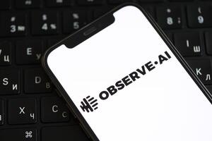 KYIV, UKRAINE - MARCH 17, 2024 ObserveAI logo on iPhone display screen and MacBook keyboard photo