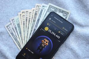 KYIV, UKRAINE - JUNE 20, 2024 Hamster Kombat tap 2 earn mini game in telegram messenger on smartphone display photo