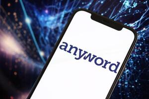 KYIV, UKRAINE - MARCH 17, 2024 Anyword logo on iPhone display screen with background of artificial intelligence futuristic image photo