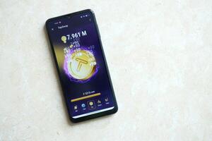 KYIV, UKRAINE - APRIL 20, 2024 Tap Swap telegram bot on smartphone screen. Tap Swap is a viral Telegram based crypto game for earn tokens by managing virtual crypto exchange photo