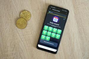 KYIV, UKRAINE - APRIL 20, 2024 Hamster Kombat telegram bot on smartphone screen. Hamster Kombat is a viral Telegram crypto game for earn HMSTR tokens by managing virtual crypto exchange photo