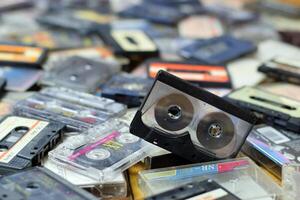 KYIV, UKRAINE - 4 MAY, 2023 Pile of audio cassettes lying on top of each other. Retro audio storage photo