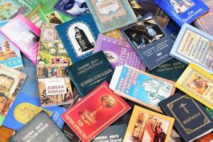 KYIV, UKRAINE - 4 MAY, 2023 Christian slavonic religious book stacked on table in chaotic order photo