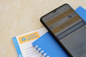 KYIV, UKRAINE - 4 MAY, 2023 Synevo medical analysis results and smartphone with synevo official website on screen photo
