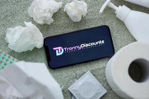 KYIV, UKRAINE - JANUARY 23, 2024 TrannyDiscounts adult content website logo on display of iPhone 12 Pro photo