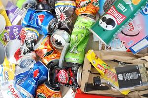 KYIV, UKRAINE - 4 MAY, 2023 Big pile of various wrappings and empty disposable packages and cups from famous branded food photo