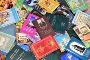 KYIV, UKRAINE - 4 MAY, 2023 Christian slavonic religious book stacked on table in chaotic order photo