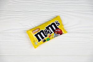 KHARKIV, UKRAINE - JANUARY 2, 2021 M and Ms colorful button shaped chocolate candies. Multi colored chocolates each of which has the letter m printed in lower case in white photo