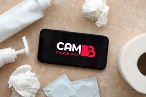 KYIV, UKRAINE - JANUARY 23, 2024 CamBB adult content website logo on display of iPhone 12 Pro photo