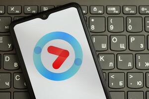 KYIV, UKRAINE - APRIL 1, 2024 Youku icon on smartphone screen on black keyboard photo