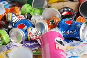 KYIV, UKRAINE - 4 MAY, 2023 Big pile of various wrappings and empty disposable packages and cups from famous branded food photo
