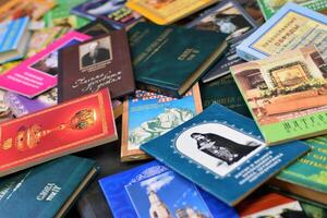KYIV, UKRAINE - 4 MAY, 2023 Christian slavonic religious book stacked on table in chaotic order photo