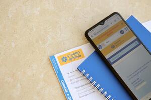 KYIV, UKRAINE - 4 MAY, 2023 Synevo medical analysis results and smartphone with synevo official website on screen photo