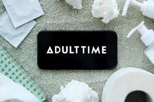 KYIV, UKRAINE - JANUARY 23, 2024 AdultTime adult content website logo on display of iPhone 12 Pro photo