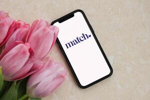KYIV, UKRAINE - FEBRUARY 23, 2024 Match logo of famous dating website or app on iPhone display photo