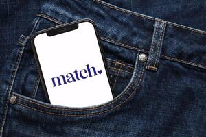 KYIV, UKRAINE - FEBRUARY 23, 2024 Match logo of famous dating website or app on iPhone display photo