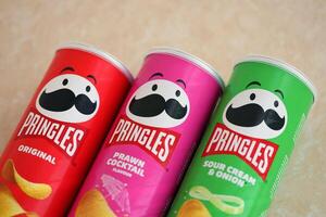 KYIV, UKRAINE - 4 MAY, 2023 Many pringles tubes of chips with various flavours photo