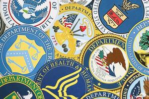 KYIV, UKRAINE - MARCH 9, 2024 Seals of United States of America Departments printed on paper photo