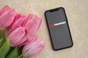 KYIV, UKRAINE - FEBRUARY 23, 2024 Adult Friend Finder logo of famous dating website or app on iPhone display photo