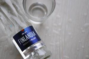 KYIV, UKRAINE - FEBRUARY 27, 2024 Bottle of famous Finlandia vodka alcohol drink on table photo
