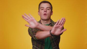 Young man say no hold palm folded crossed hands in stop gesture, warning of finish prohibited access video