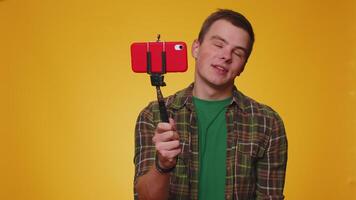 Man blogger take selfie on mobile phone selfie stick communicate call online with subscribers video