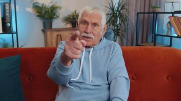 Senior elderly man smiling, pointing to camera, choosing lucky winner, indicating, inviting, approve video