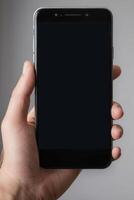 Close-up of a person's hand holding a smartphone photo