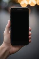 Close-up of a person's hand holding a smartphone photo