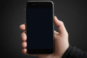 Close-up of a person's hand holding a smartphone photo