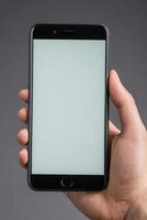 Close-up of a person's hand holding a smartphone photo