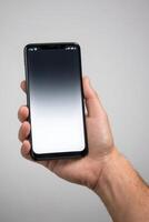 Close-up of a person's hand holding a smartphone photo