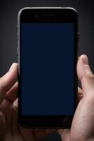 Close-up of a person's hand holding a smartphone photo