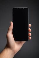 Close-up of a person's hand holding a smartphone photo