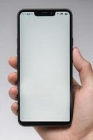Close-up of a person's hand holding a smartphone photo