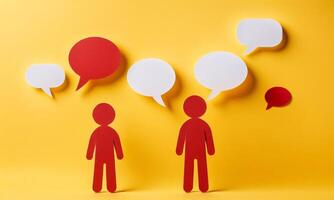 Red paper cut team talking with chat or speech bubbles, teamwork concept, isolated on yellow background photo