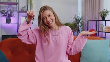 Woman real estate agent showing the keys of new home house apartment, buying or renting property video