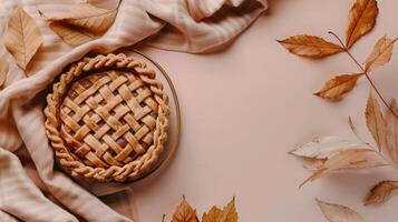 Boho top view Thanksgiving day with brown pumpkin pie and leaves photo