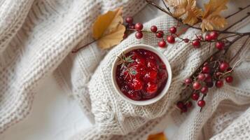 Boho top view Thanksgiving day with small bowl of cranberry sauce and autumn decor photo