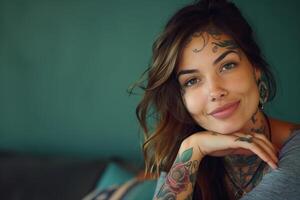 Young woman with tattoos smiling and leaning on arm photo