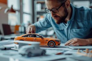 Car designer examining concept car model in studio photo