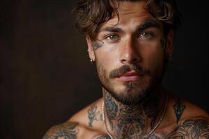 Portrait of a handsome man with tattoos and facial piercing photo