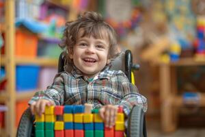 Smiling boy in a wheelchair plays with blocks in a classroom photo