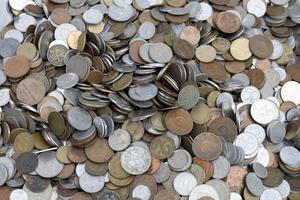 A pile of coins of various sizes and colors photo